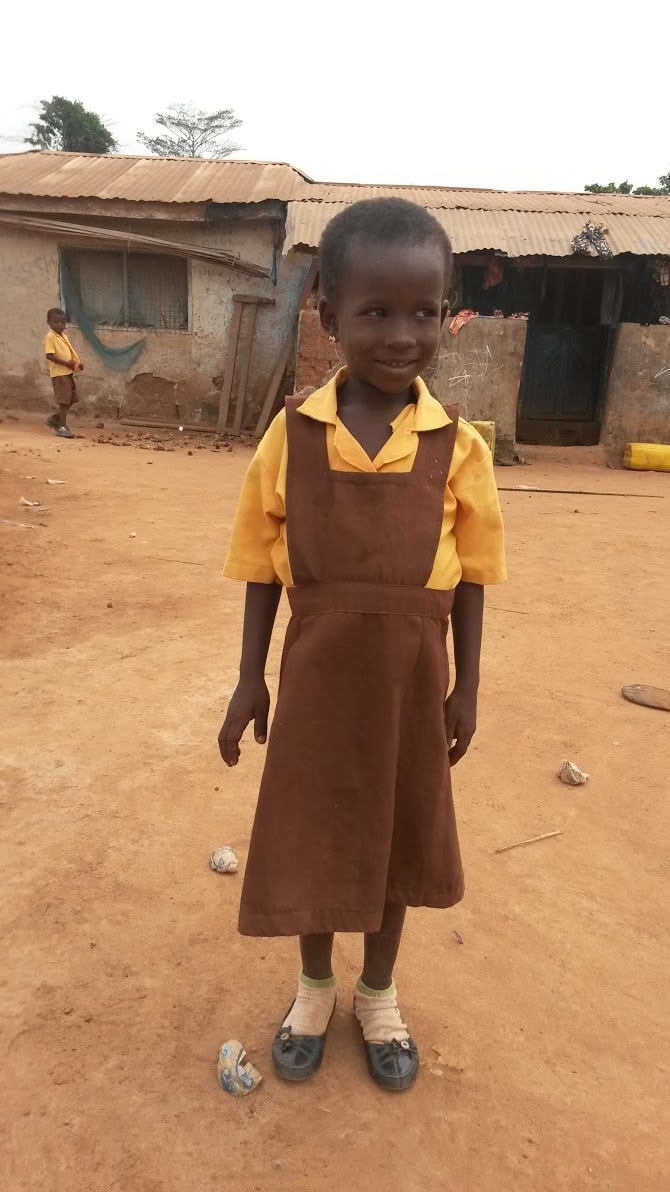 little girls in school uniform poses for picture