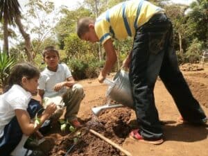 20140424 Anas children plant and water seedings using SHI equipment Grid7