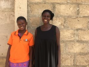 Vera and her mother Vivian smile against a brick wall