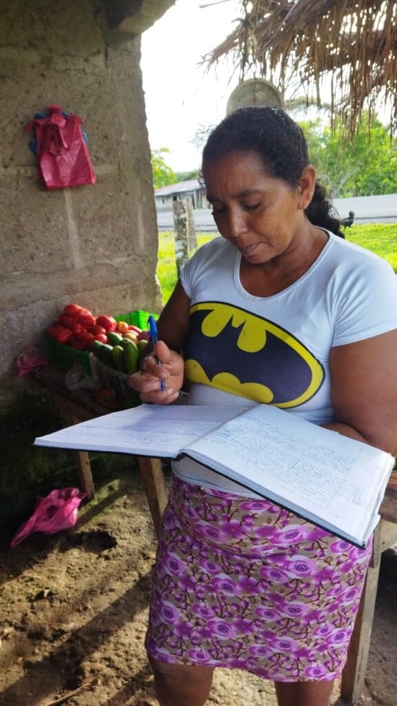 Photo of Carla keeping record of her business