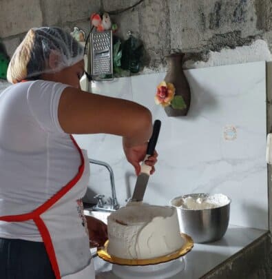 Martha frosting the cake