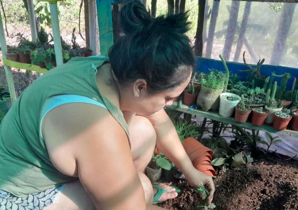 Heydi tending to her plants.