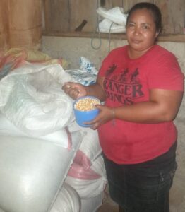Osneyda is proud of her corn harvest.