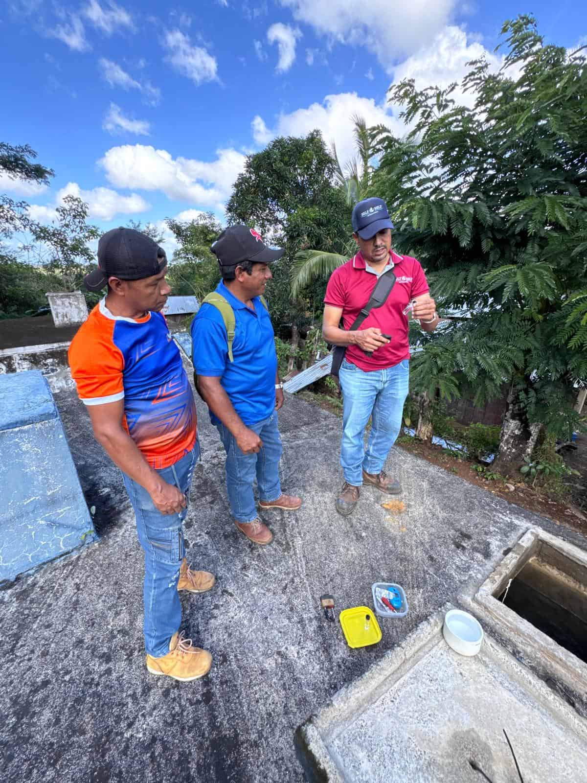 Self-Help International Clean Water Program Officer Orlando Montiel Salas with Never Oporta CAPS officers.