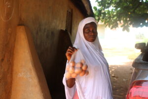 A woman in Ghana's Ashanti Region shows off a bag of eggs.
