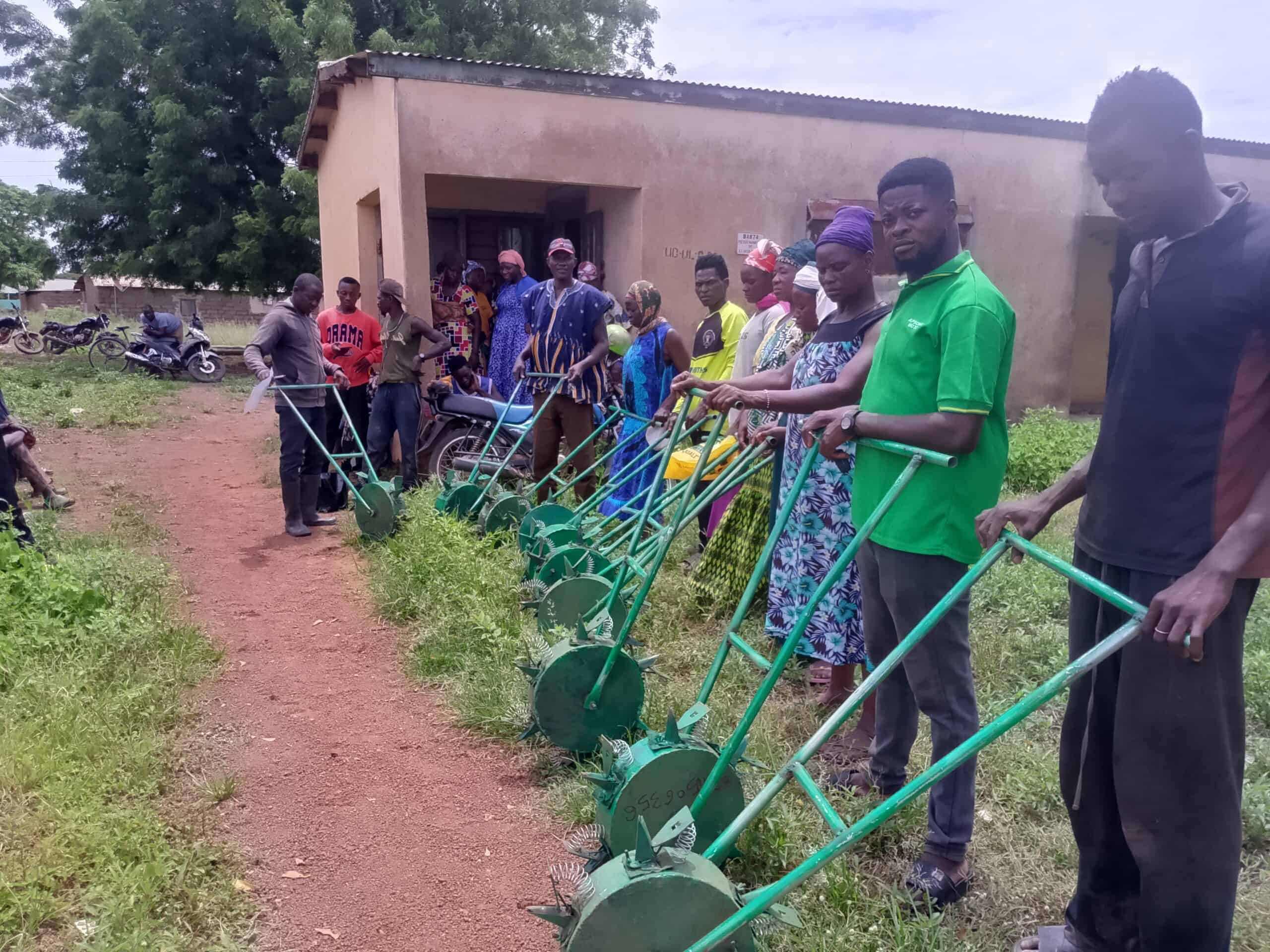 Self-Help International training farmers on their new push planters.