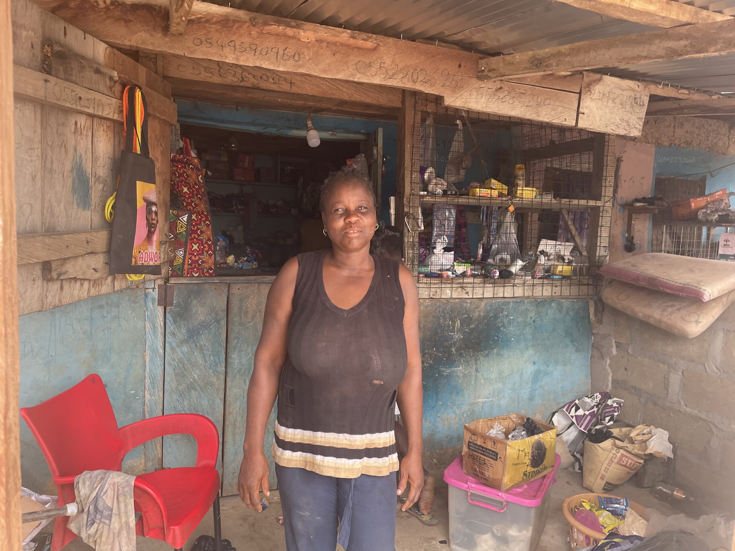 Ruth, a Self-Help International microcredit client, sells provisions from her shop.