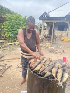 Ruth Thrives With Support from Self-Help International 1 Ruth, a Self-Help International microcredit client, cooks fish to sell in her shop.